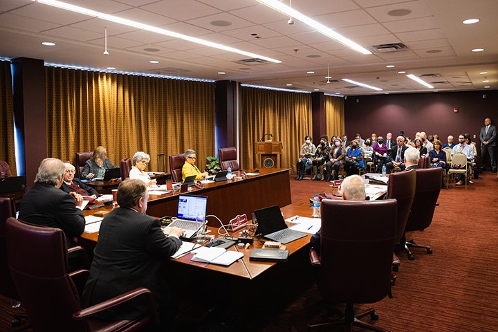 Members of the Board of Trustees gather to meet.