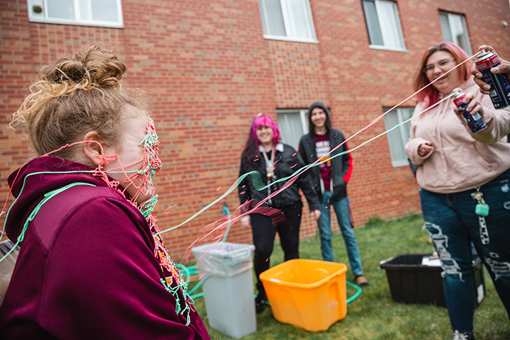 A student takes a face full of silly string during the end of year carnival hosted by the CMU Police Department.