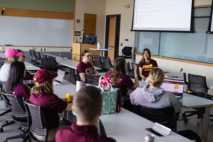 Professor Dawn Decker in a classroom with students.