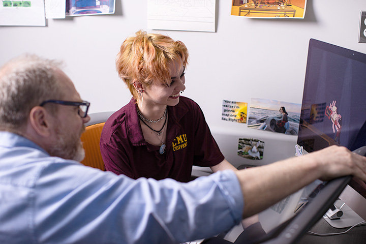 Animation major Stephanie Shaw works with professor Steve Leeper on her projects.