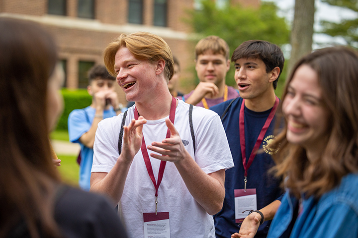Incoming students bond and play games in front of Warriner Hall during orientation.