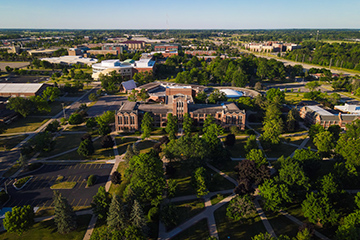 Warriner Hall sits at the center of this aerial view of campus on a summer day.