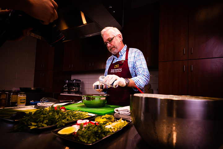 Jeffrey Fisher, associate professor of dietetics, makes taco salad in Wightman Hall.