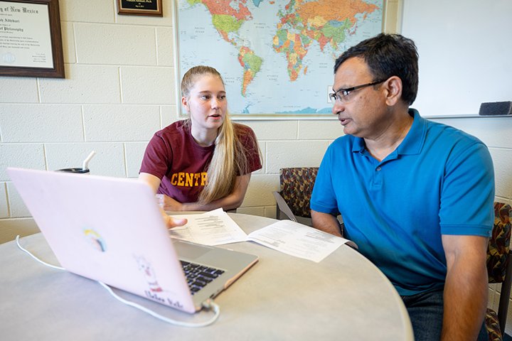 McNair Scholar Natalie Stetler (left) and their mentor, political science professor Prakash Adhikari, discuss their latest research.