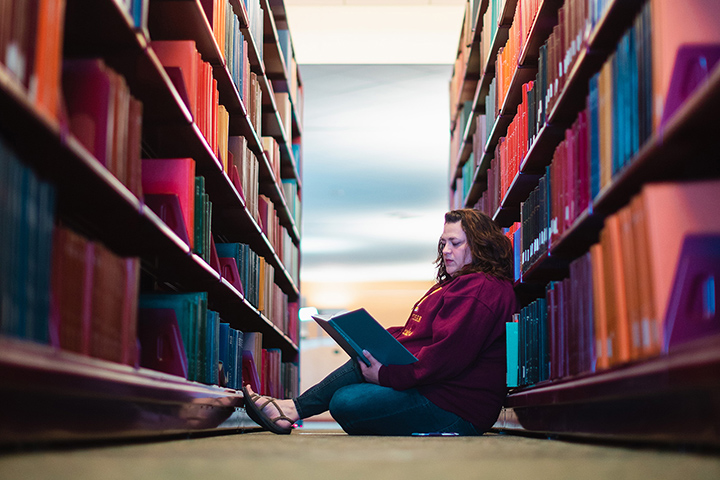 McNair Scholar Tashia Evans studies in the stacks at Charles V. Park Library.