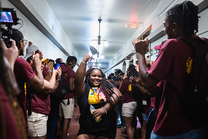 CMU students cheer in the hallway during IMPACT.