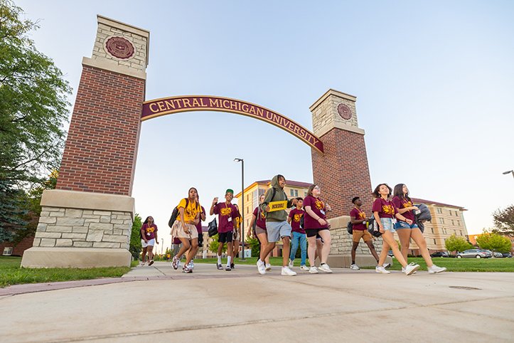 IMPACT attendees walk under the CMU arch on their way to the Student Activities Center.