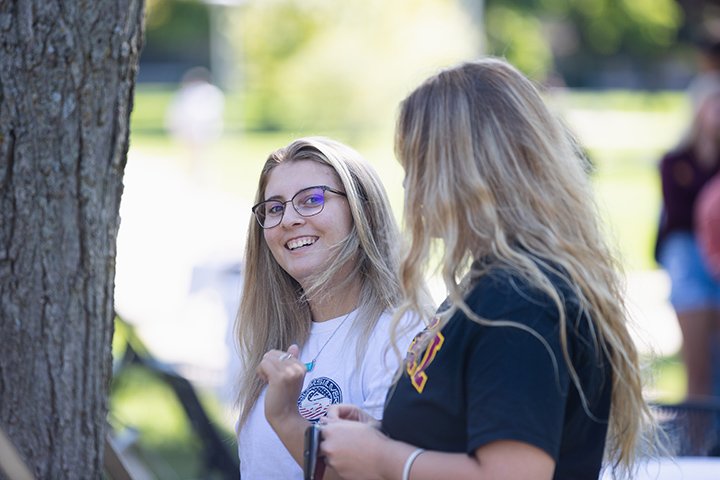 Two students smile at each other during the Ice Cream Social.