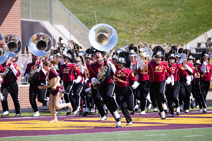 The CMU Marching Band rushes the field during the football home opener against South Alabama on Saturday, Sept. 10.