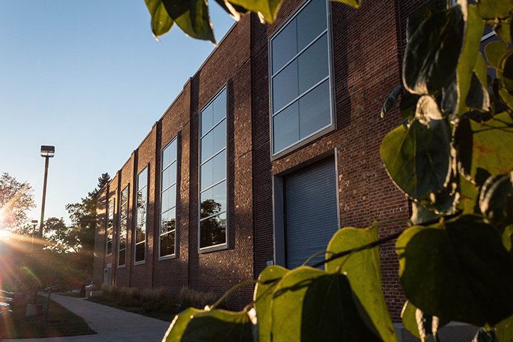 The sun shines just before sunset over Finch Fieldhouse.