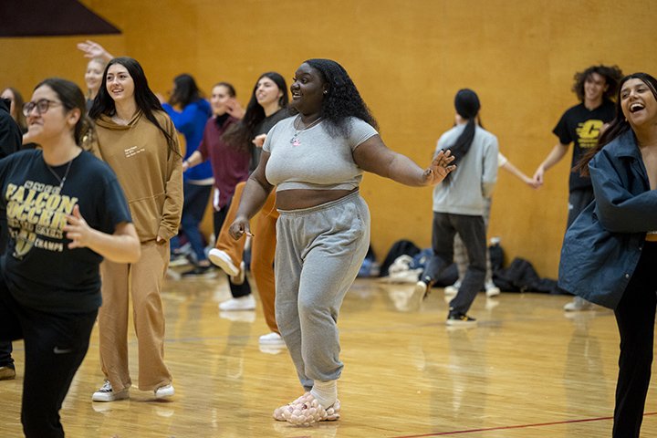 Students smile while dancing and learning a variety of Pow wow dance styles.
