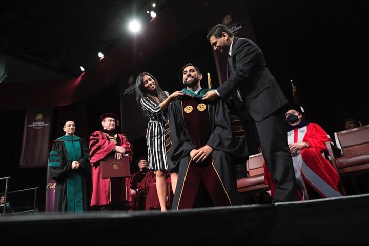 A CMU student is honored during commencement.