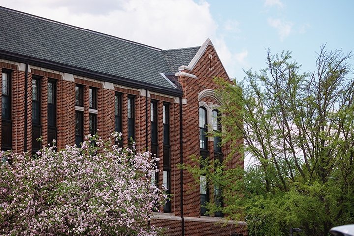 Warriner Hall peers through the trees.