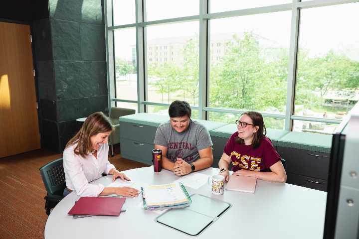 Education students Olivia Gregory and Brandon Beebe sit with Special Education faculty member Dawn Decker in the EHS building.