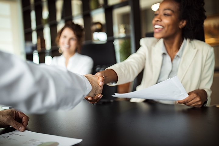 Job interview stock photo of people shaking hands. From Getty Images.