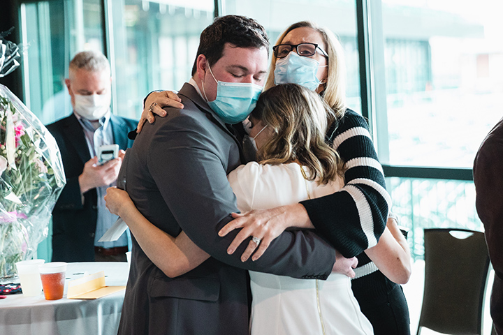 A medical student hugs her parents at Match Day.
