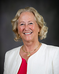 Nancy Mathews, executive vice president and provost for Central Michigan University, poses for a photo in a white blazer