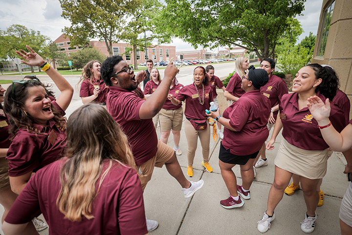 Orientation leaders get “fired up” by leading a cheer in front of the Park Library.