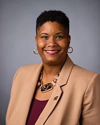 Renee Watson, vice president of student affairs for Central Michigan University, poses for a photo in a tan blazer.