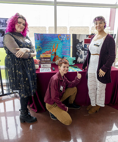 Students in CMU's animation program stand in front of a display of their project at the New Venture Challenge's Campus Innovation Showcase.
