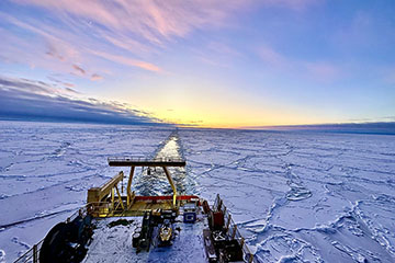 The sun rises on the wake of the R/V Nathaniel B. Palmer as it sails in the Southern Ocean.