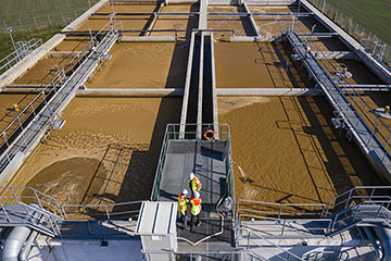 People inspect a wastewater treatment facility.