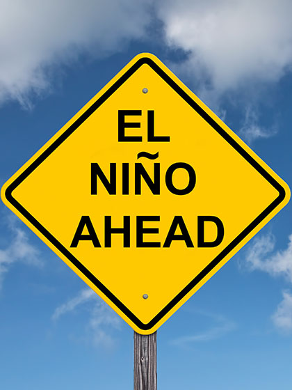 A yellow sign in front of a blue sky. The words El nino ahead are on the sign.