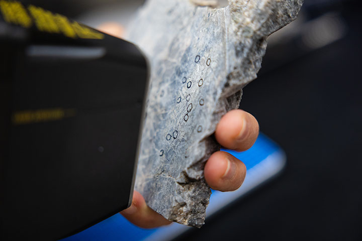 Potential deposits of lithium, identified with circles, are analyzed by a piece of portable test equipment.