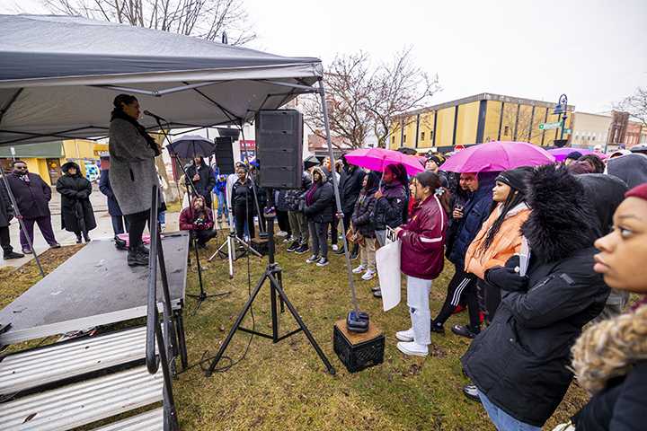 Shawna Patterson-Stephenson stands on a stage in downtown Mt. Pleasant addressing a crowd of onlookers who participated in the MLK Peace March.