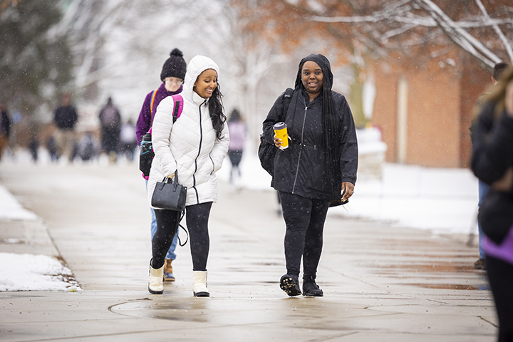 Students walk through CMU's campus on a snowy day.