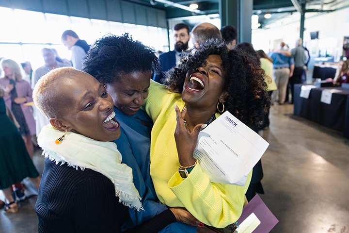 A medical student celebrates with her family.