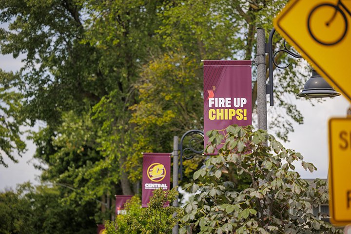 Three maroon banners with the words 