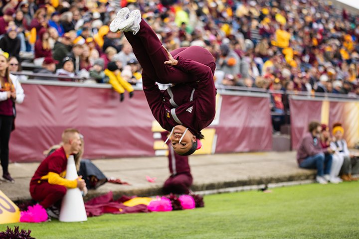 A CMU cheerleader goes head over heels at the homecoming game.