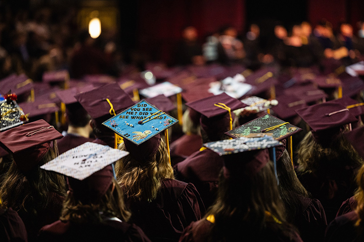 A closeup of the tops of dozens of CMU graduates, focused on the tops of their hats. One reads: 