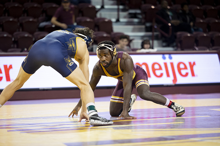 CMU wrestler Tracy Hubbard grapples with a member of Kent State University's wrestling team.