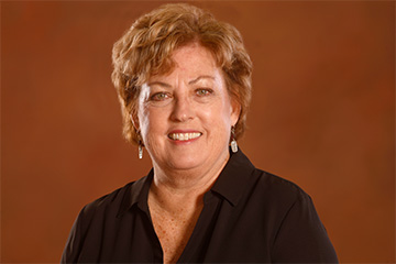 Headshot of Betty Kirby, Vice President for Innovation and Online wearing a black blouse smiling for the camera.