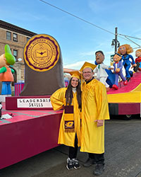 CMU graduate Donna Diggs and her dad, graduate John Diggs, pose next to the CMU parade float.