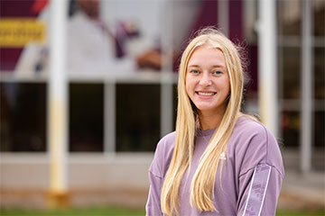 Taylor Griffith, new CMU student standing outwide while on campus.