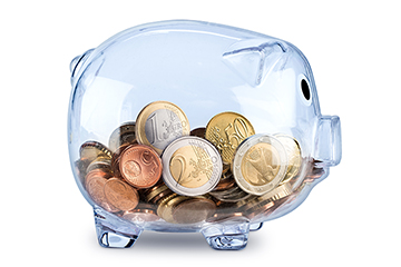 Coins inside a transparent piggy bank.