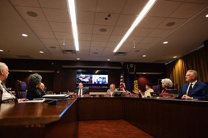 The CMU Board of Trustees sit at a C-shaped table.