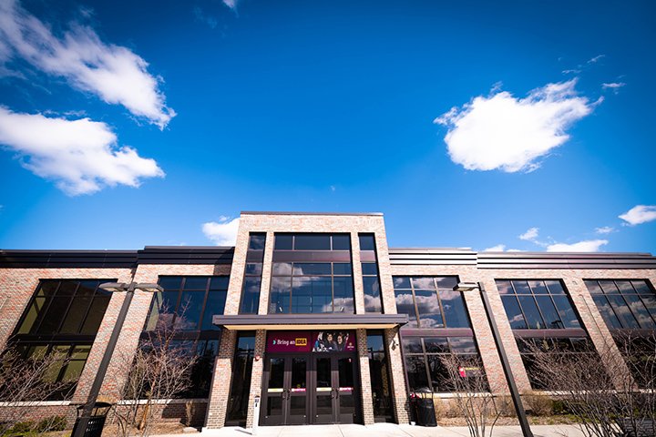 A beautiful blue sky with white clouds over Grawn Hall.