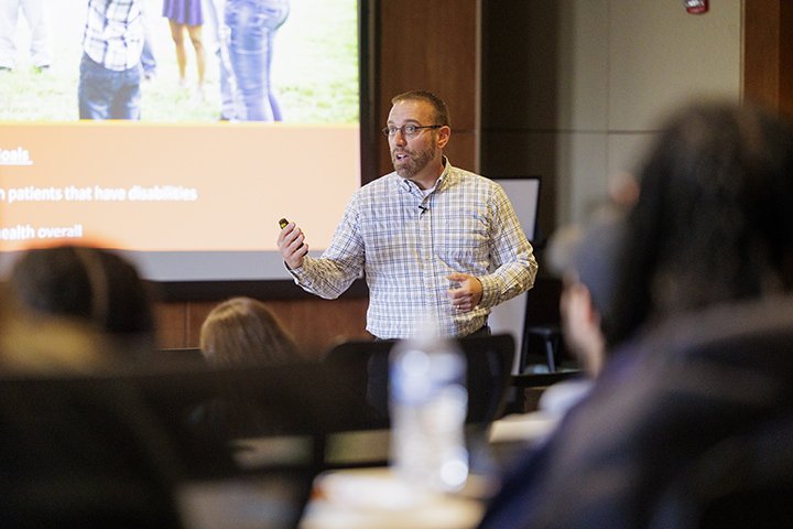 Faculty member Shay Dawson stands in front of a classroom full of students in the CMU College of Medicine.