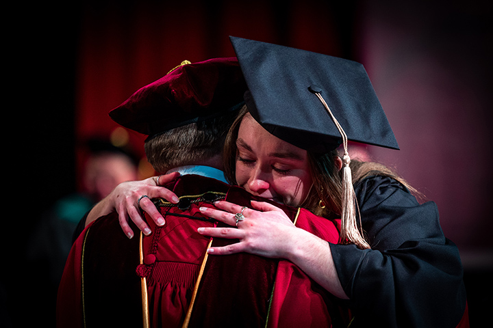 At CMU spring commencement, President Davies receives a teary eyed hug from his daughter, Katie.