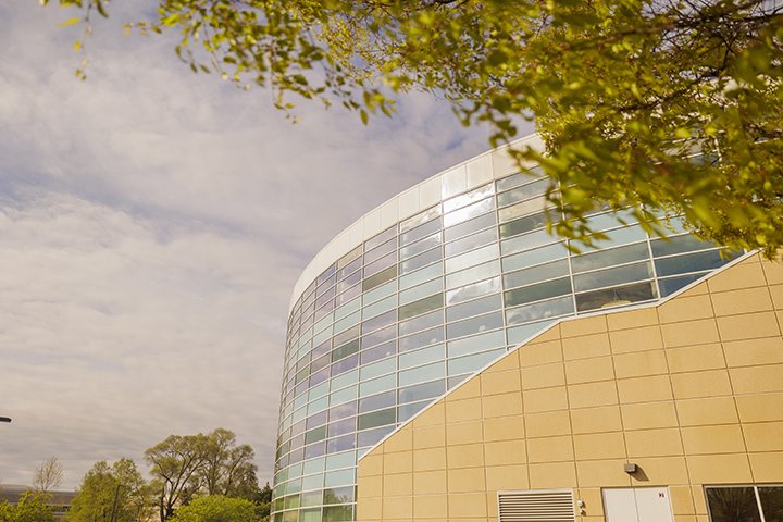 A blue sky with white clouds over the Park Library.