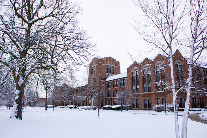 A view of a snow-covered Warriner Hall from a distance as the ground and trees surrounding the building are also covered in snow.