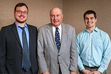 Philip Kintzele, emeritus professor of accounting, pictured with two scholarship recipients at a 2014 scholarship event.