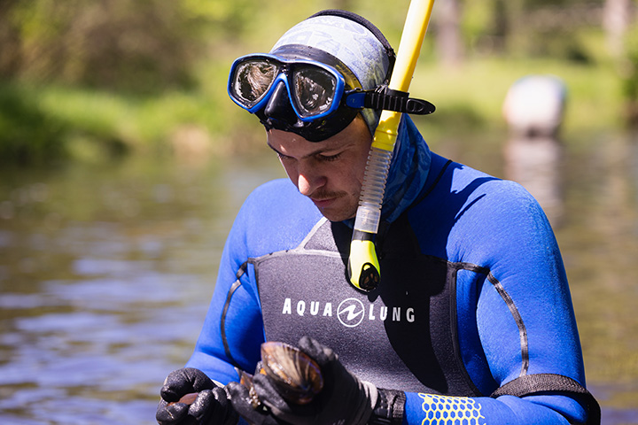 A man wearing a diving suit and goggles.