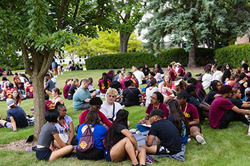 A group of people sitting on the grass