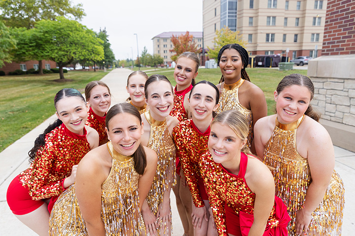 A group of girls wearing matching dance outfits