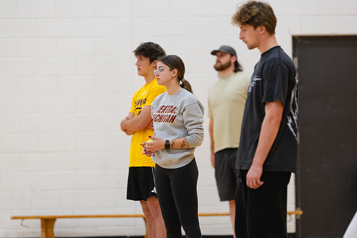 A group of people standing in a gym
